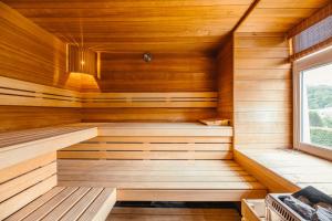 a sauna with wooden walls and a window at Villa Louise in Durbuy