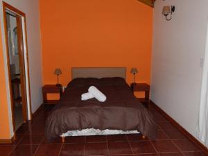 a bedroom with a bed with two pillows on it at Piedra Caliza in Tandil +34 photos