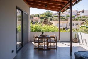 a room with a table and chairs on a balcony at MV Living - Retreat in Daratso