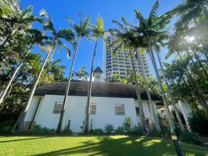 黄金海岸Boutique Ocean View Studio with King Bed & Spa的一座高楼前有棕榈树的建筑