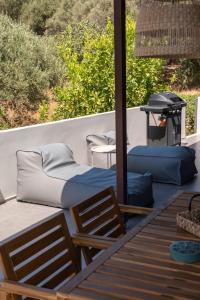 a deck with two beds and a grill on it at MV Living - Retreat in Daratso