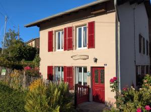 a house with red shutters and a red door at Gîte à deux pas de Center Parcs Les Trois Forêts in Bertrambois