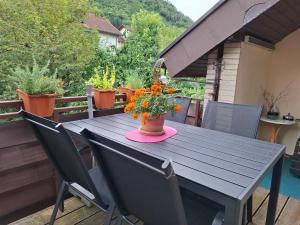a wooden table with a vase of flowers on a deck at Sterngässle in Deggingen