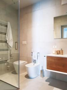 a bathroom with a toilet and a sink at AR Boutique Apartments in Bergamo