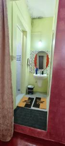 a bathroom with a sink and a mirror at Nisarga Coorg Home Stay in Somvārpet