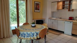 a kitchen with a table with a table cloth on it at Gite Mimosa - Private Pool, Sainte-Valière, South of France in Sainte-Vallière
