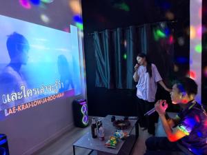 a young boy is playing a video game on a stage at Paradise Resort & Cafe in Ban Mae Khon