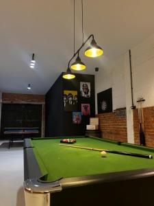 a room with a pool table in a room with at Apartamenty Pod Dębami in Sarbsk