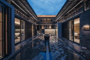 a courtyard of an asian building with a pool at PingYao Chengfu Jinyuan Hotel in Pingyao