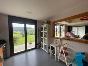 a kitchen with a large window and a view of a field at Espaciosa con vistas in Villaviciosa