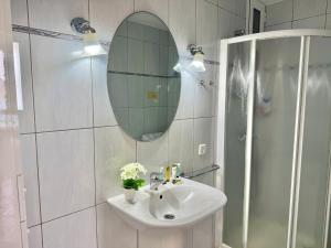 a bathroom with a sink and a mirror and a shower at Doñana 16 in Patalavaca +19 photos