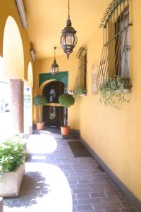 un pasillo con tres lavabos en un edificio con macetas en Albergo Della Corona, en Binasco