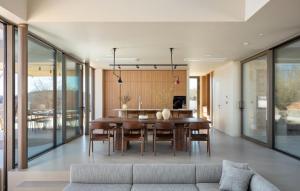 a dining room with a table and a couch at Villa bOX by Villas Guide in Brajkovići