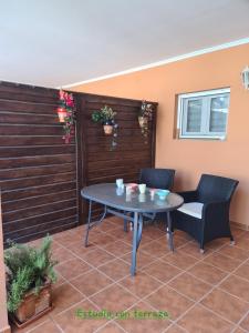 a patio with a table and two chairs on it at Die kleine Auszeit in Denia +15 photos