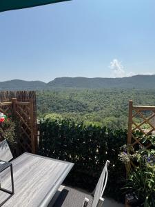 a table and chairs on a balcony with a view of the mountains at KATELL BeachHouse in Bagnols-en-Forêt +9 photos