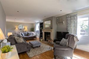 a living room filled with furniture and a fireplace at Country Family Retreat in Bradford on Avon