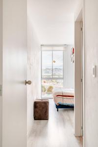 a bedroom with a bed and a window at Stylish & Modern 2BR Apartment in Quito