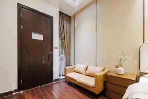 a living room with a chair and a door at SEEU Designer Apartment in Shenzhen