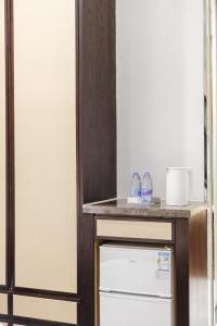 a kitchen with a counter on top of a refrigerator at SEEU Designer Apartment in Shenzhen