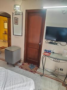 a room with a bed and a television and a table at Sonam Regency inn pvt ltd in Jāmb