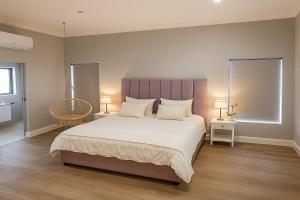 a bedroom with a large bed and two lamps at 1442 Marina by Double Portion in Jeffreys Bay +21 photos