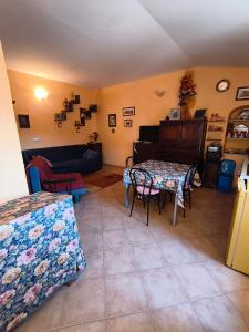 a living room with a table and a couch at La Casa Arancione in Lacedonia +1 photo