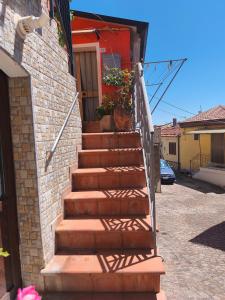 a stairway leading up to a house with potted plants at La Casa Arancione in Lacedonia