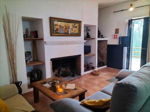 a living room with a couch and a fireplace at Casa rural Alicia in Cortegana