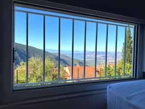 a bedroom with a large window with a view at ΝΝ Delphi Loft in Delphi