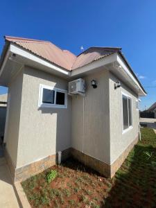 a small house with a red roof at La Million Palace - Dodoma in Dodoma