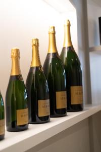 a row of green bottles of wine sitting on a shelf at Le Clos Haton - HAUTVILLERS in Hautvillers +57 photos