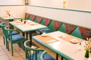 a row of tables and chairs in a restaurant at Apart Hotel Leipzig Taucha in Taucha