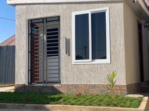 a house with a window and a shutter at La Million Palace - Dodoma in Dodoma