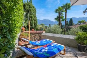 a pair of beach chairs sitting on a patio at Residenza del Pascià in Oggebio