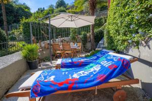 a table with a blue blanket on it with an umbrella at Residenza del Pascià in Oggebio +46 photos