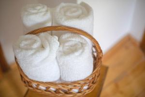 a basket filled with white towels on a table at Aura's Guest House in Sadova +49 photos