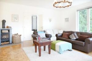 a living room with a leather couch and a table at White Villa in Baden