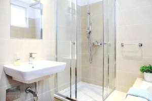 a bathroom with a sink and a shower at White Villa in Baden