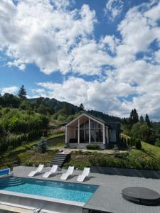 a villa with a swimming pool and a house at Rest Hub in Slavske