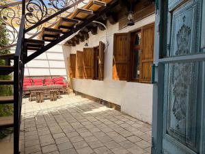 an open door of a building with red benches and windows at Usman Heritage in Bukhara