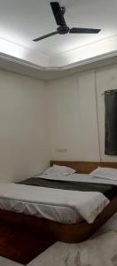 a bedroom with two beds and a ceiling fan at Nest-In Homes in Hyderabad