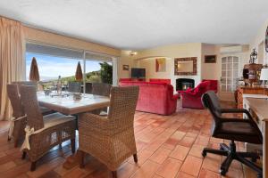a living room with a table and chairs and a couch at Villa Bellevue Avec Vue Mer in Saint-Peïre-sur-Mer