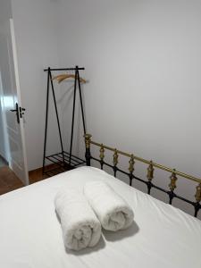 a bed with two towels sitting on top of it at Casa rural Aires de Magina Jaén in Carchel +29 photos