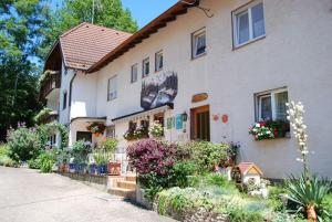 a house with flowers and plants in front of it at Pension Schneider in Freiamt
