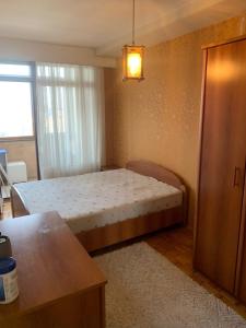 a small bedroom with a bed in a room at Bregu diellii,nice wiew of Pr in Pristina