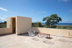 a group of chairs and a table on a patio at Beach Villa Pasithea in Neokhórion
