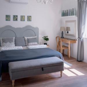 a bedroom with a large bed and a table at Grafit vendégház in Nagyrákos