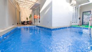 a large swimming pool with blue water in a building at Villa Sunrise with Private Pool in Dau