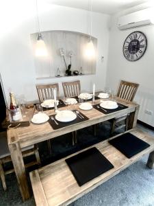 a wooden table with chairs and a dining room at Ferienwohnung Hella in Kippenheim +40 photos
