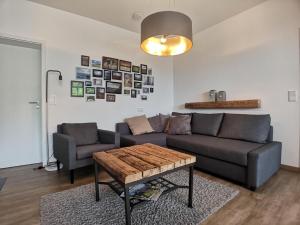 a living room with a couch and a table at Appartement "Am Schlosshang" mit Terrasse in Waldmünchen